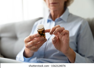 Sick Ill Old Senior Woman Hold Pills Bottle Read Medicine Prescription Label, Elderly Grandma Looking At Medicine Instructions Side Effects, Older People Pharmacy Medicament Concept, Close Up View