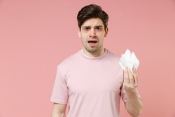 Sick Ill Tired Crying Allergic Man Has Watery Red Eyes Runny Nose Suffer From Allergy Hay Fever Hold Paper Napkin Isolated On Pastel Pink Color Background Studio. Spring Rhinitis Reaction On Trigger