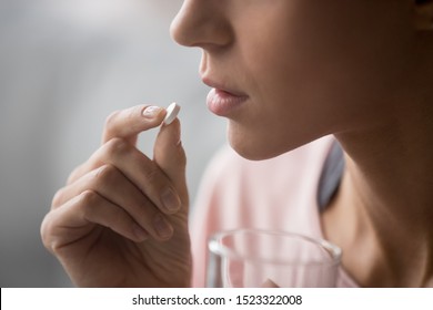 Sick Ill Woman Holding Antidepressant Painkiller Antibiotic Pill Glass Of Water Take Medicine, Female Handing Tablet Meds To Mouth To Relieve Pain, Health Care Medicament Concept, Close Up Side View