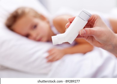 Sick Kid With Inhaler In Foreground - Asthma Or Other Respiratory Illness