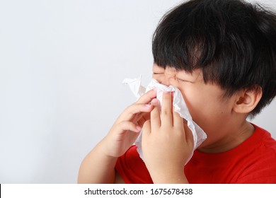 Sick Little Asian Boy Sneezing With Tissue. Allergic Kid, Flu Season. Kid With Cold Rhinitis.