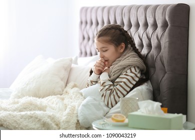 Sick Little Girl With Cough Suffering From Cold In Bed