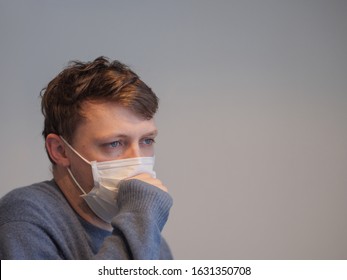 Sick Man Coughing In A Surgical Mask