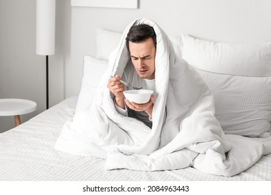 Sick Man Eating Chicken Soup At Home