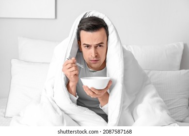 Sick Man Eating Chicken Soup At Home