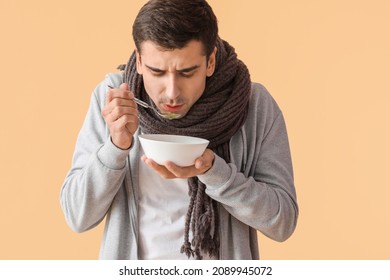 Sick Man Eating Chicken Soup On Color Background