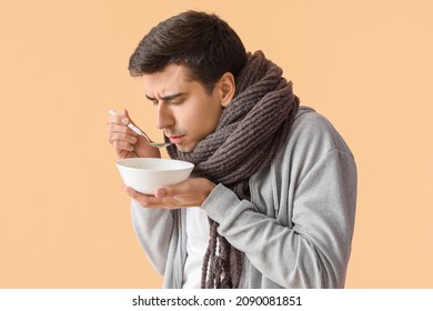 Sick Man Eating Chicken Soup On Color Background