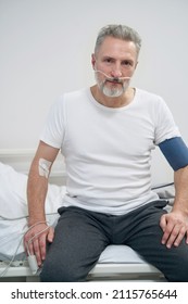 Sick Man Getting Supplemental Oxygen Through Nose Tubes