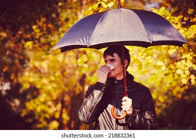 Sick Man Holding Umbrella  And  Blowing Nose At Autumn Day