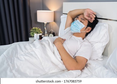 Sick Man In Medical Mask Is Headache And Suffering From Virus Disease And Fever In Bed, Coronavirus (covid-19) Pandemic Concept.