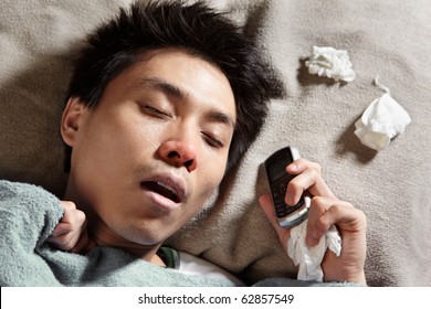 A Sick Man Sleeping While Holding His Cell Phone