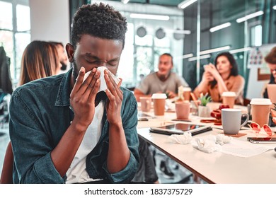 Sick Man Sneezing In Office. Influenza Virus. Coronavirus.