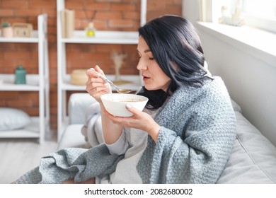 Sick Mature Woman Eating Chicken Soup At Home