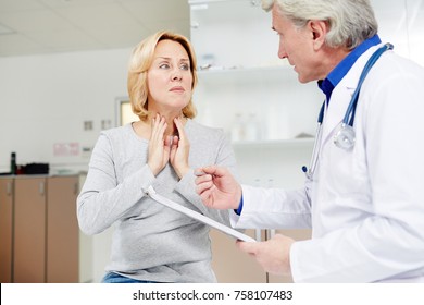 Sick Mid-aged Female Complaining About Sore Throat To Her Doctor