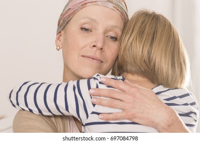 Sick Mother With Brain Tumor Tightly Hugging Her Little Child