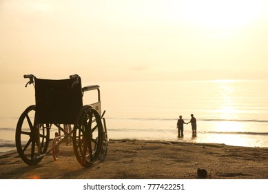 A sick old woman came to the beach with her strong daughter in a wheelchair and held her hand and held it close to her. - Powered by Shutterstock