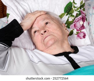 Sick Old Woman Lying In Bed