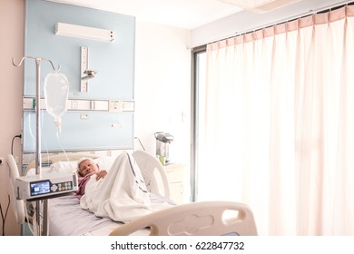 Sick Older Woman Lying In Hospital Bed