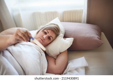 Sick Overweight Woman Lying In Bed At Home.