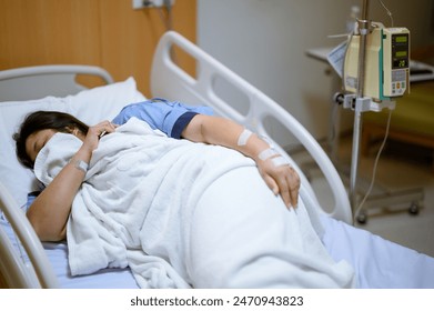 A sick patient lies in a hospital bed. - Powered by Shutterstock