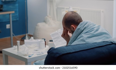 Sick Patient Reading Leaflet Information Of Medication To Cure Healthcare Problems. Man With Disease Looking At Medicament Paper For Healing Treatment Against Illness. Ill Adult