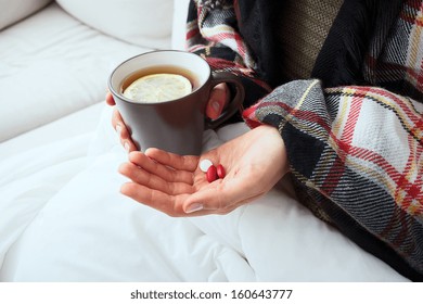 Sick Person Is Taking Medicines And Drinking Hot Tea With Lemon