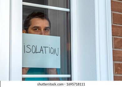 Sick Sad Man Is On Self-isolation, Looking Through The Window. Covid 19 Coronavirus Pandemic And Quarantine Concept. Self-isolation Stops The Spread Of COVID-19. Isolation At Home For Self Quarantine.