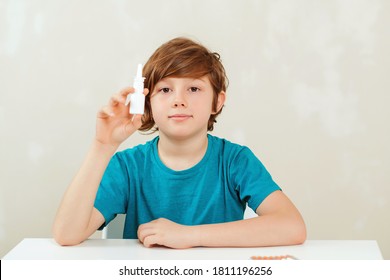 Sick School Boy With Runny Nose Using Nasal Medicine Spray. Nasal Allergy. Kid With Ill Disease Treatment Season. Allergic Kid, Flu Season. Boy Has A Virus, Runny Nose And Headache. 