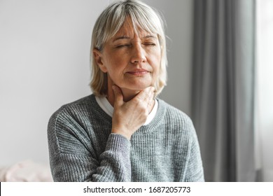 Sick Senior Adult Elderly Women Touching The Neck Feeling Unwell Coughing With Sore Throat Pain.Healthcare And Medicine Concept