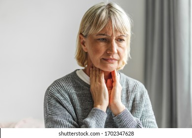 Sick Senior Adult Elderly Women Touching The Neck Feeling Unwell Coughing With Sore Throat Pain.Healthcare And Medicine Concept