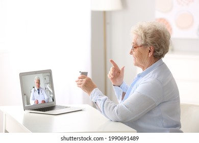 Sick senior woman getting online consultation at home - Powered by Shutterstock