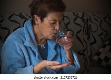 Sick Senior Woman Taking Medication