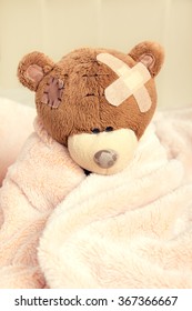 Sick Teddy Bear With Patch In Bed