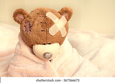 Sick Teddy Bear With Patch In Bed