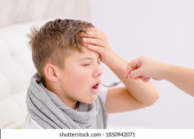 Sick Teen Boy Take Medication Pouring In A Spoon From Mom.