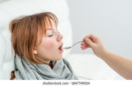 Sick Teen Girl Take Medication Pouring In A Spoon From Mom