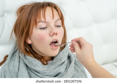 Sick Teen Girl Take Medication Pouring In A Spoon From Mom