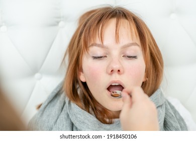 Sick Teen Girl Take Medication Pouring In A Spoon From Mother