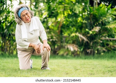 Sick unhappy senior adult elderly asian woman touching her muscle injury leg suffering from muscles knee pain ache in park at home.physical injury and  healthcare problem - Shutterstock ID 2152148445