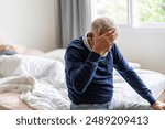 Sick unhappy senior elderly man touching head serious depressed feeling headache thinking of problem, alzheimer, cancer, stroke, parkinson, disease and cerebral haemorrage