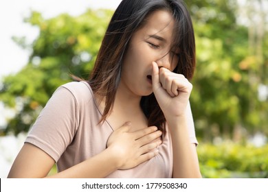 Sick Unvaccinated Asian Woman Having Sore Throat, Concept Of Sickness With Coughing, Hiccupping, Choking, Acid Reflux, Long Covid Or Post Covid Syndrome