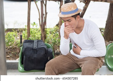 sick unvaccinated man traveler, traveling and have problem with coronavirus infection, pneumonia, nausea, stomachache, vomit, acid reflux
