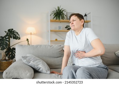 Sick Upset Middle Aged Lady Hold Belly Suffer From Abdomen Ache Concept, Mature Old Adult Woman Feel Morning Pain Hurt In Stomach Abdominal Gastritis Pancreatitis Diarrhea Problem Symptom Sit On Bed