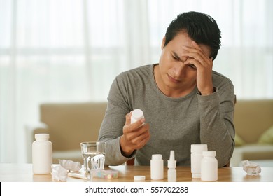 Sick Vietnamese Man Choosing Medicine To Take