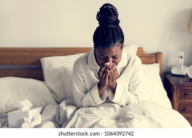 A sick woman in bed - Powered by Shutterstock