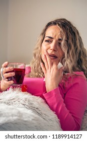 Sick Woman In Bed, Calling In Sick, Day Off From Work. Drinking Herbal Tea. Vitamins And Hot Tea For Flu. Woman Caught Cold. Virus.
