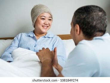 A sick woman in bed with her partner