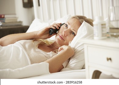 Sick Woman In Bed At Home Talking On Phone