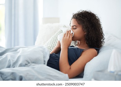 Sick woman, bedroom and blowing nose for sinus infection, allergies and tissue for hayfever. Female person, home and toilet paper for cold or flu virus, recovery and respiratory influenza or disease - Powered by Shutterstock