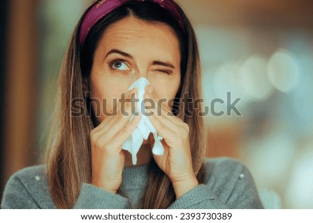 
Sick Woman Blowing her Nose Suffering from Influenza. Unhappy girl feeling unwell after viral infection symptoms begin
